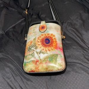 Sunflower Painted cross body with phone and zippered interior compartments.